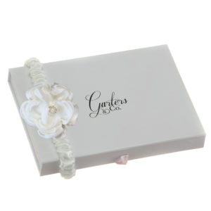 Soft satin rose on garter with embellishment