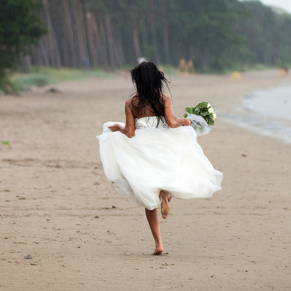 Bride running along the Beach